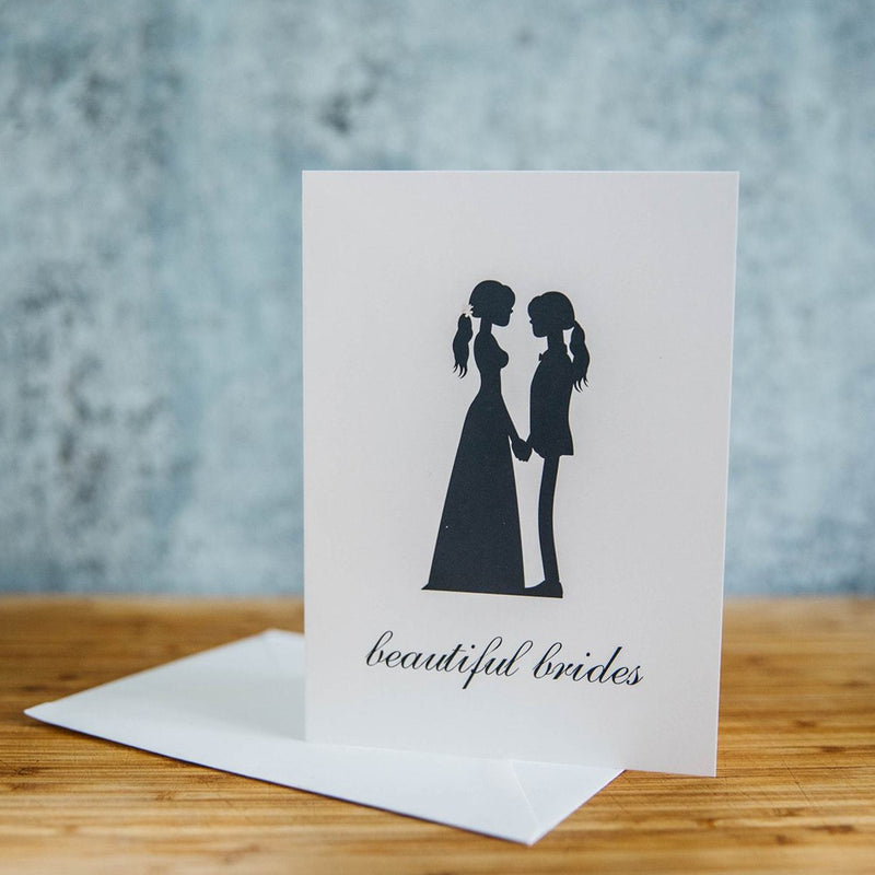 Black Silhouette of Two Beautiful Brides - One in Dress and One in Suit with Long Hair  - White Background - LGBTQ+ Greeting Card