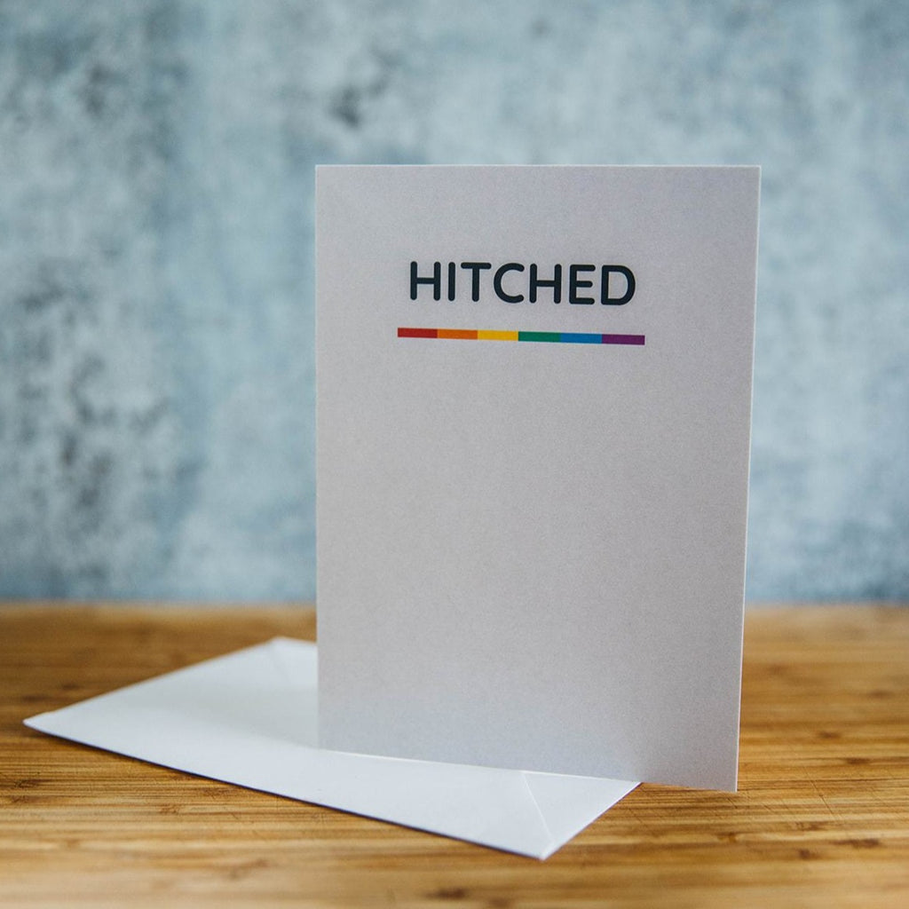 Hitched with Rainbow line on white LGBT Wedding Greeting Card