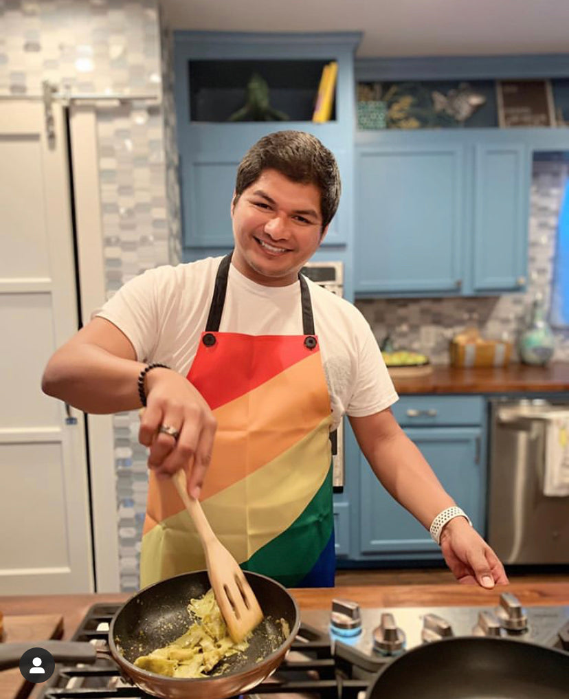 Person Cooking While Wearing Rainbow Apron