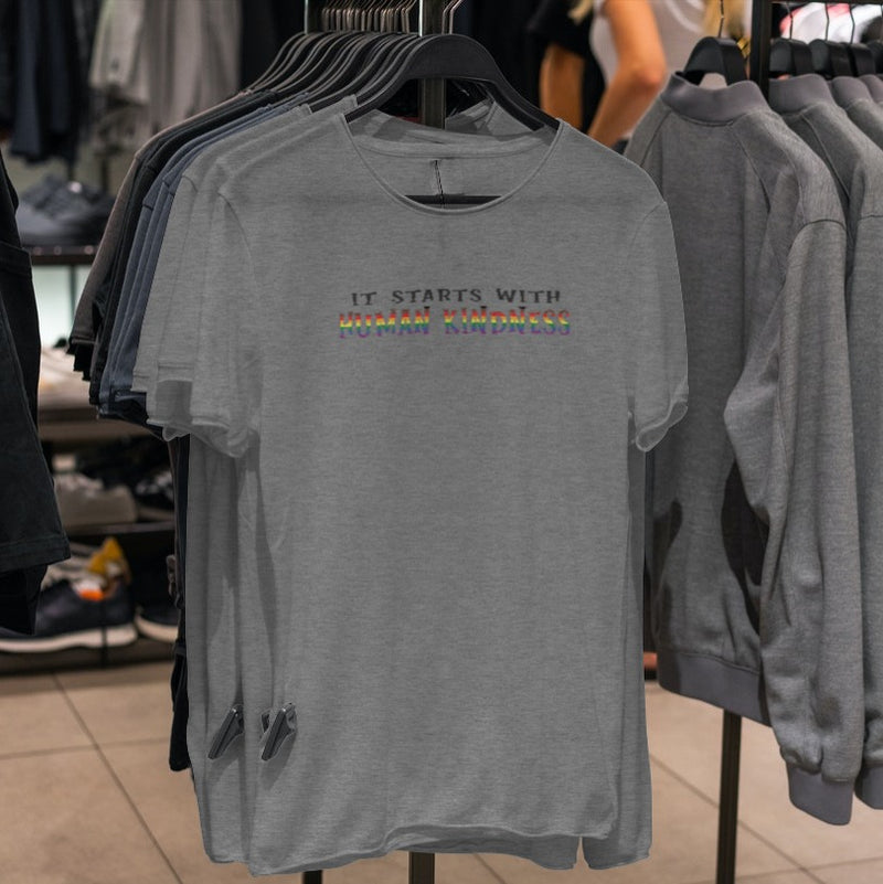 LGBTQ+ Pride Shirt - It Starts With Human Kindness - Heather Grey shirts on hangers