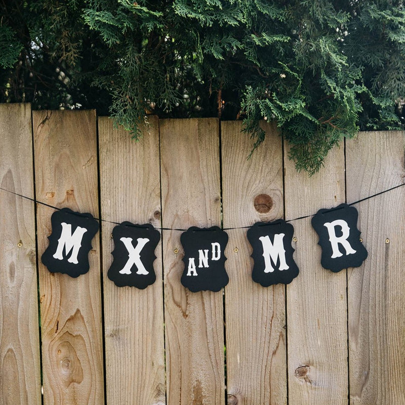 Mx and Mr Black Craft Banner Hanging from Wooden Fence