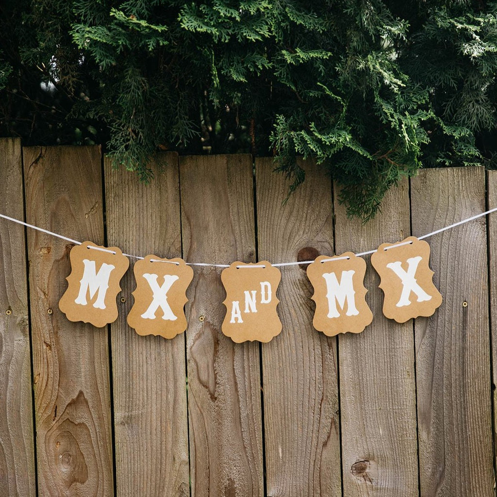 Mx and Mx Brown Craft Banner Hanging from Wooden Fence